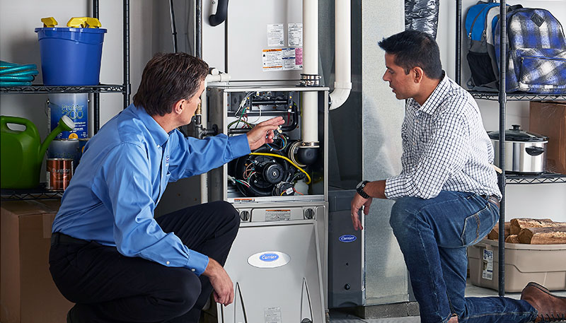 HVAC technician evaluating a furnace for repair or replacement in Erie