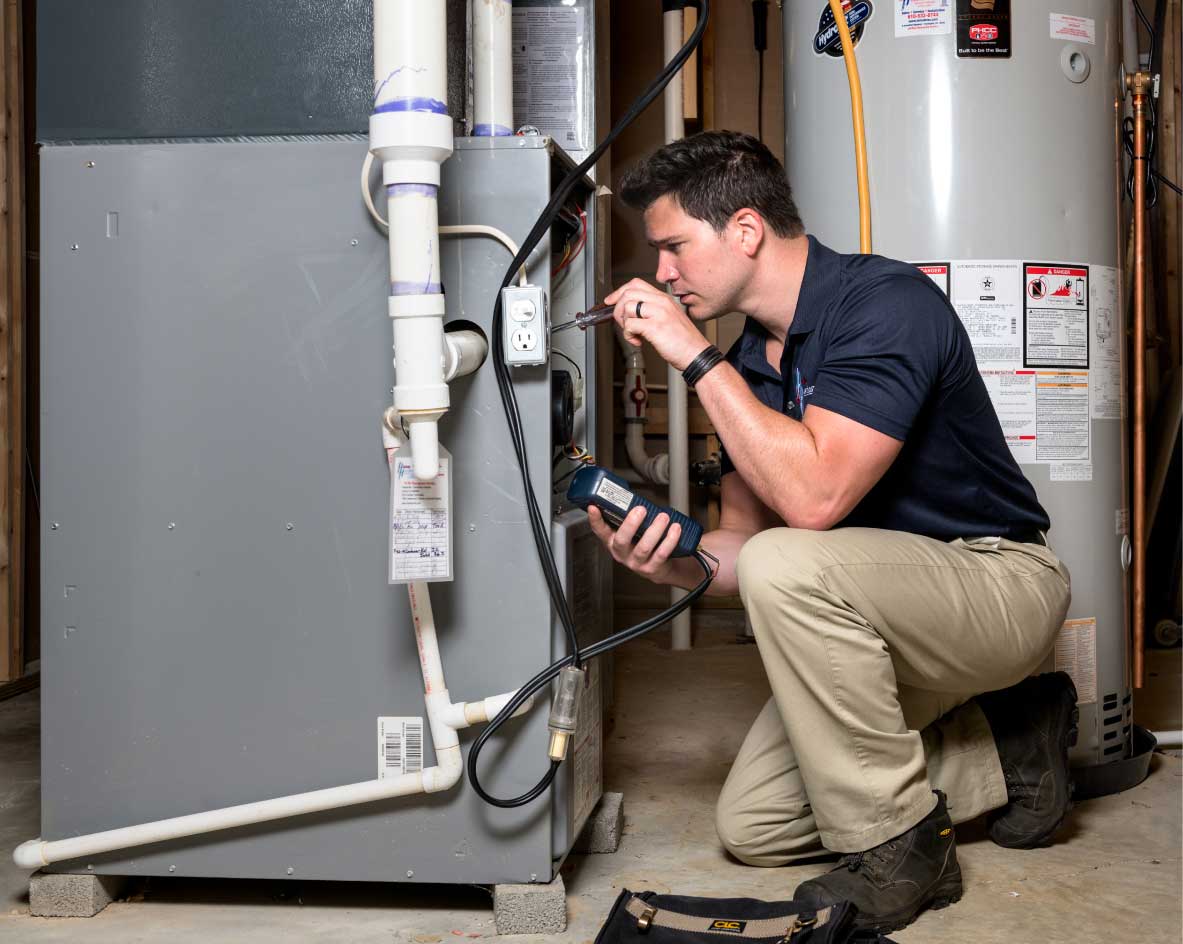 HVAC technician performing a furnace tune-up in Erie