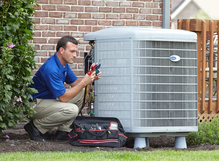 HVAC technician inspecting an outdoor air conditioning unit in Erie