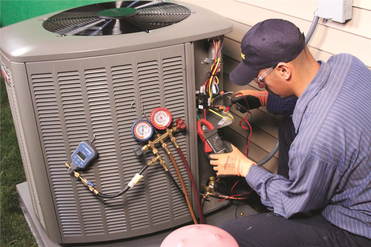HVAC technician testing an outdoor air conditioning unit in Erie
